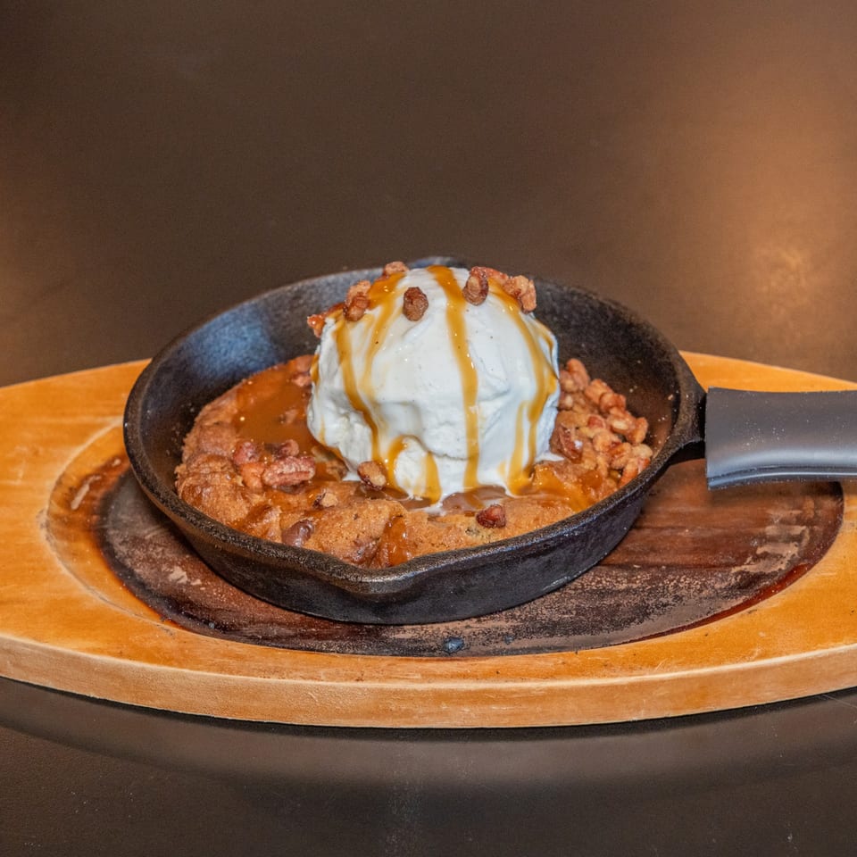Cookie skillet topped with ice cream.