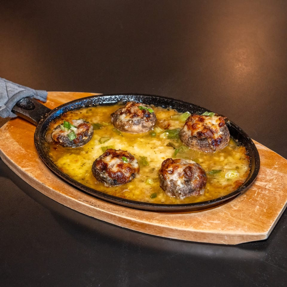 Stuffed mushrooms in a skillet.