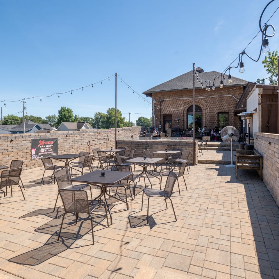 Outdoor patio seating beneath string lights.
