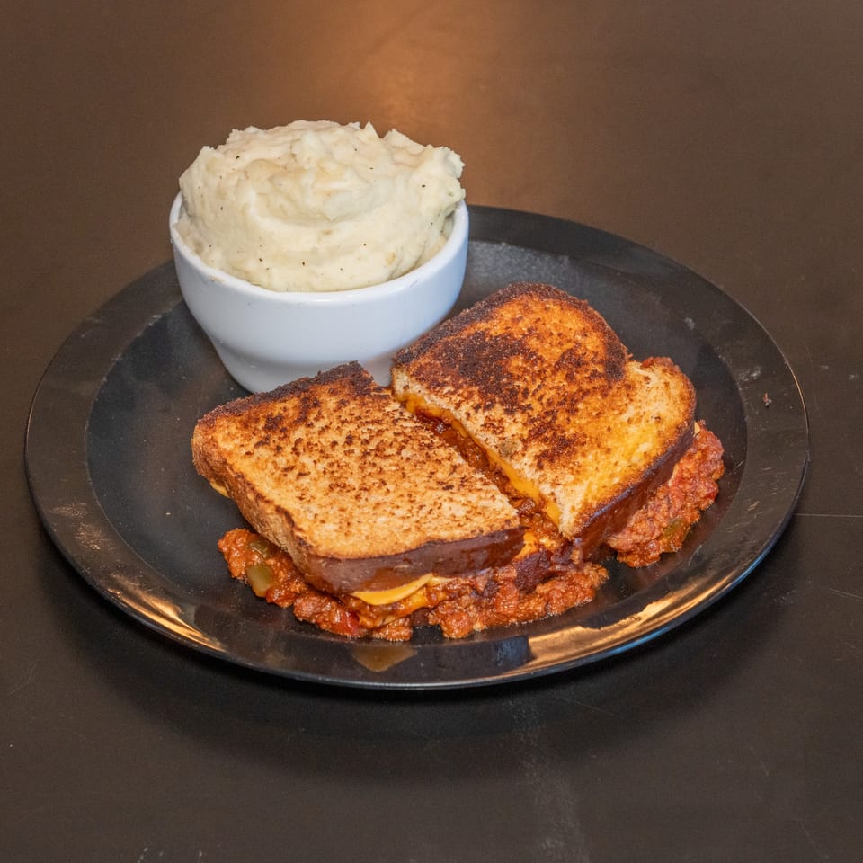Stuffed grilled cheese with sloppy joe and mashed potatoes.